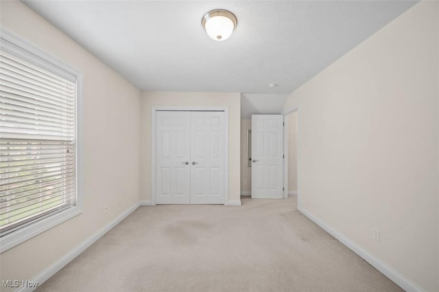 4819 Trails End Ct, Westlake, OH 44145 - unfurnished bedroom with a closet, light carpet, and baseboards