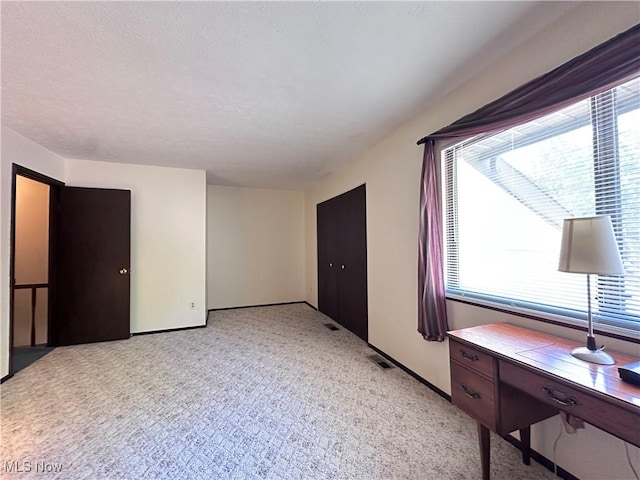 547 Towns Ln Unit 129, Richmond Heights, OH 44143 - unfurnished bedroom with multiple windows, light colored carpet, and baseboards