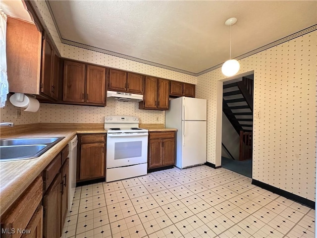 547 Towns Ln Unit 129, Richmond Heights, OH 44143 - kitchen featuring white appliances, wallpapered walls, under cabinet range hood, a sink, and light countertops