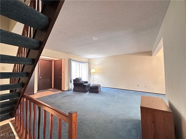 547 Towns Ln Unit 129, Richmond Heights, OH 44143 - sitting room with carpet, a textured ceiling, and stairway