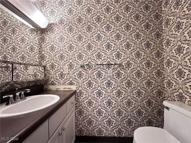 547 Towns Ln Unit 129, Richmond Heights, OH 44143 - bathroom with vanity, toilet, and wallpapered walls