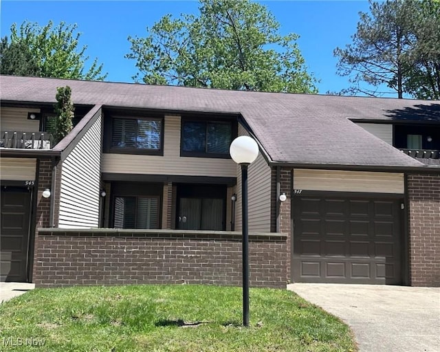 547 Towns Ln Unit 129, Richmond Heights, OH 44143 - view of front of house featuring brick siding, concrete driveway, and an attached garage