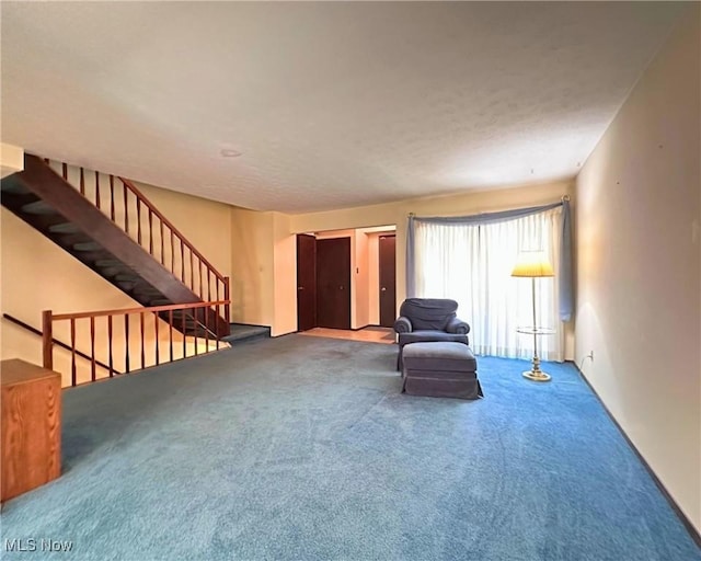 547 Towns Ln Unit 129, Richmond Heights, OH 44143 - living area featuring carpet floors, stairway, and a textured ceiling