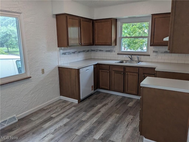 871 Chinook Ave, Akron, OH 44305 - kitchen featuring white dishwasher, a textured wall, a sink, tasteful backsplash, and dark wood finished floors