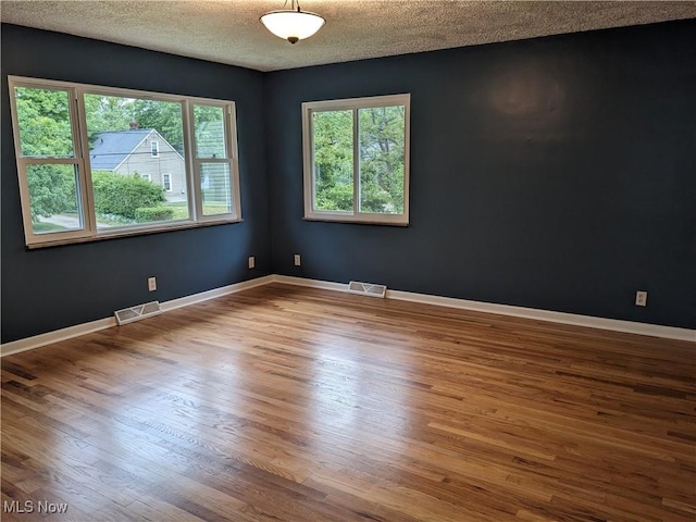871 Chinook Ave, Akron, OH 44305 - empty room featuring wood finished floors, a textured ceiling, and baseboards