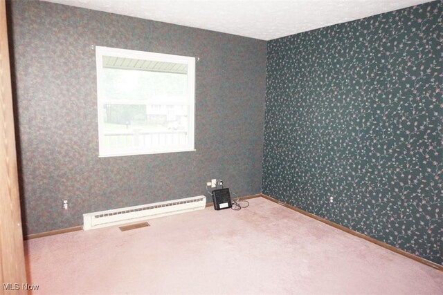1259 Cherry Ln, Brunswick, OH 44212 - carpeted empty room featuring a baseboard radiator, wallpapered walls, and baseboards