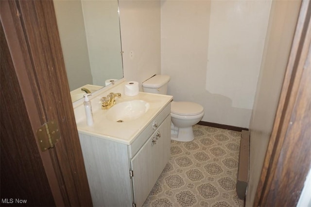 1259 Cherry Ln, Brunswick, OH 44212 - half bathroom with vanity, toilet, and baseboards