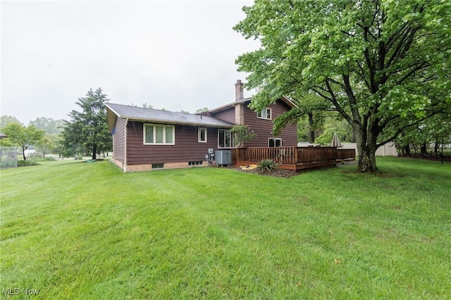 5761 Goodman Cir, North Royalton, OH 44133 - rear view of house with a chimney, a wooden deck, cooling unit, and a lawn