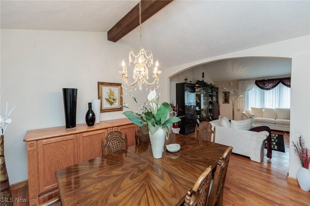 5761 Goodman Cir, North Royalton, OH 44133 - dining room featuring arched walkways, a chandelier, and light wood finished floors