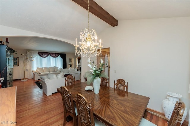 5761 Goodman Cir, North Royalton, OH 44133 - dining space with arched walkways, light wood-style floors, a chandelier, and baseboards