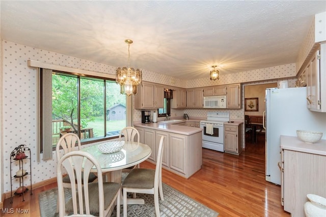 5761 Goodman Cir, North Royalton, OH 44133 - kitchen featuring white appliances, wallpapered walls, light countertops, a sink, and light wood-type flooring