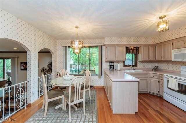 5761 Goodman Cir, North Royalton, OH 44133 - kitchen featuring white appliances, wallpapered walls, a sink, light countertops, and wood finished floors