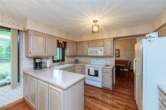 5761 Goodman Cir, North Royalton, OH 44133 - kitchen with white appliances, wallpapered walls, a peninsula, a sink, and light wood finished floors