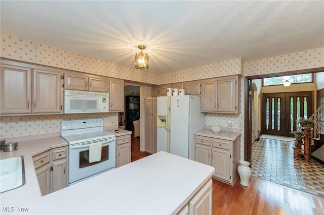 5761 Goodman Cir, North Royalton, OH 44133 - kitchen with white appliances, light countertops, wallpapered walls, light wood finished floors, and a sink