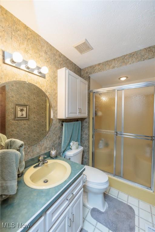 5761 Goodman Cir, North Royalton, OH 44133 - bathroom featuring vanity, a shower stall, tile patterned flooring, and toilet