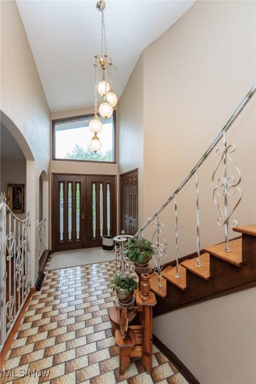 5761 Goodman Cir, North Royalton, OH 44133 - entrance foyer with high vaulted ceiling, arched walkways, and stairway