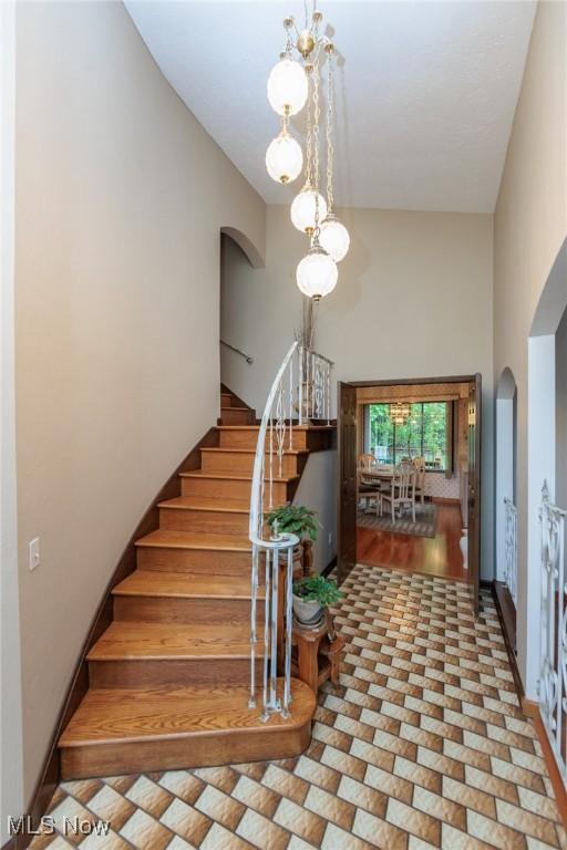 5761 Goodman Cir, North Royalton, OH 44133 - stairs with arched walkways and a towering ceiling