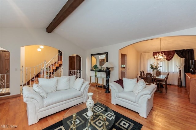 5761 Goodman Cir, North Royalton, OH 44133 - living area with arched walkways, a chandelier, light wood-style flooring, and stairway