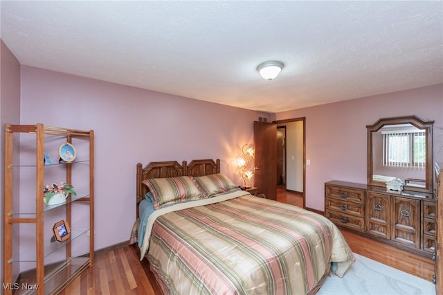 5761 Goodman Cir, North Royalton, OH 44133 - bedroom with wood finished floors and a textured ceiling