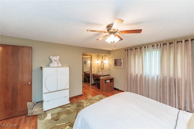 5761 Goodman Cir, North Royalton, OH 44133 - bedroom with wood finished floors, ceiling fan, and ensuite bath