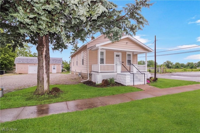 1515 E 3rd St, Port Clinton, OH 43452 - shotgun-style home with covered porch, a front yard, and driveway