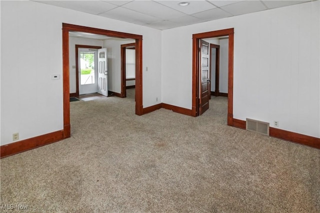 1515 E 3rd St, Port Clinton, OH 43452 - unfurnished room with baseboards, carpet flooring, and a drop ceiling