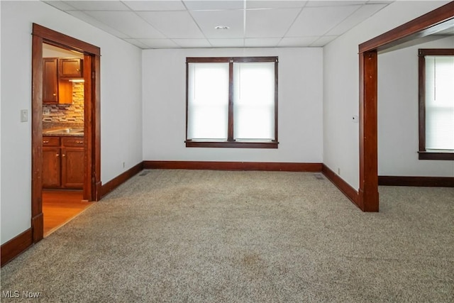 1515 E 3rd St, Port Clinton, OH 43452 - carpeted spare room featuring a paneled ceiling, baseboards, and healthy amount of natural light