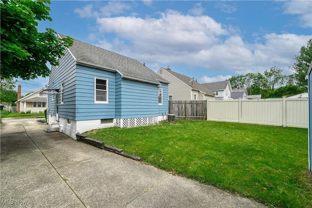 1923 15th St SW, Akron, OH 44314 - back of property with cooling unit and roof with shingles