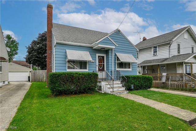 1923 15th St SW, Akron, OH 44314 - view of front of property featuring a garage, a chimney, and roof with shingles