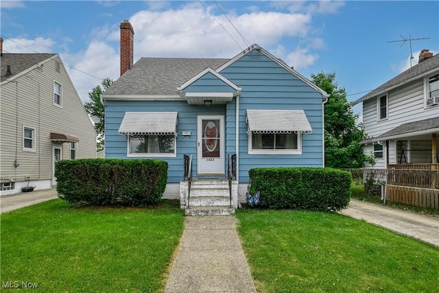 1923 15th St SW, Akron, OH 44314 - bungalow with entry steps, a chimney, and a shingled roof