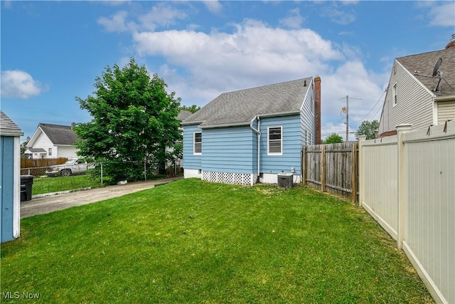 1923 15th St SW, Akron, OH 44314 - back of house featuring a shingled roof and central AC unit