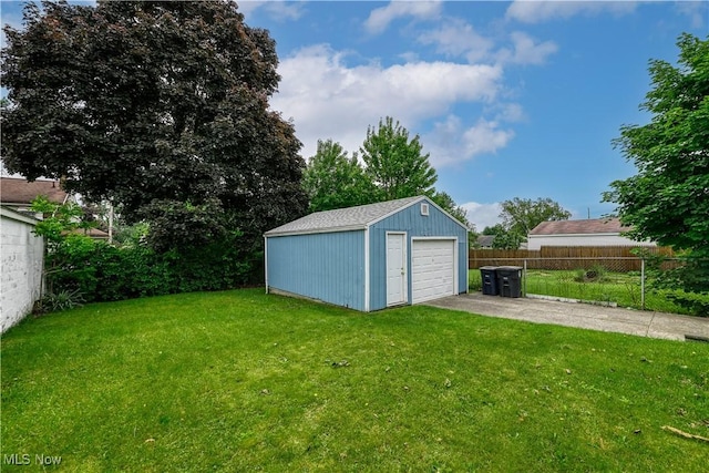 1923 15th St SW, Akron, OH 44314 - view of yard featuring a garage, an outbuilding, and driveway