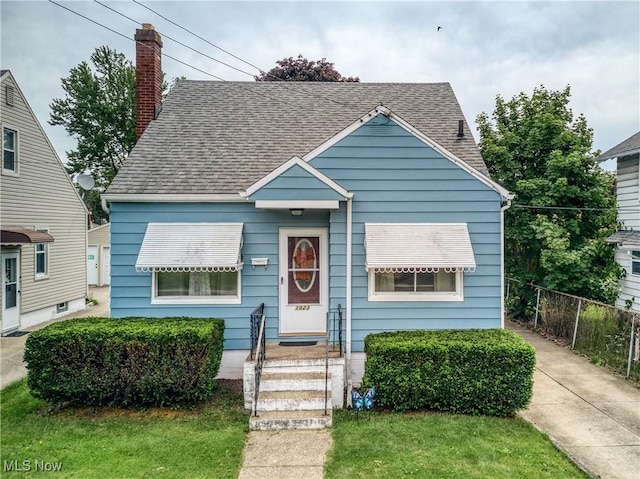 1923 15th St SW, Akron, OH 44314 - bungalow-style home with roof with shingles and a chimney
