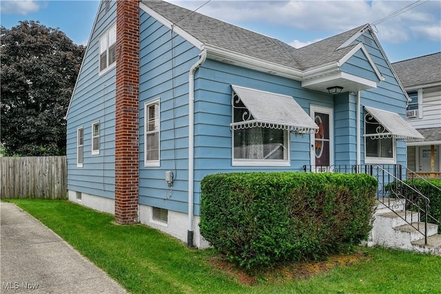 1923 15th St SW, Akron, OH 44314 - view of side of property with a chimney and roof with shingles