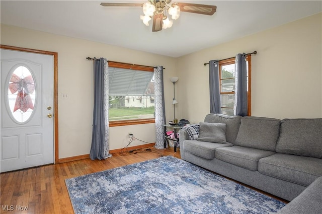 1923 15th St SW, Akron, OH 44314 - living room with a ceiling fan, wood finished floors, and baseboards