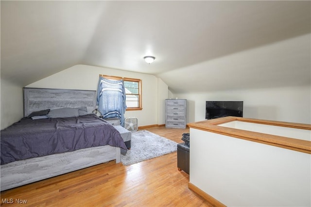 1923 15th St SW, Akron, OH 44314 - bedroom with vaulted ceiling and light wood-style flooring