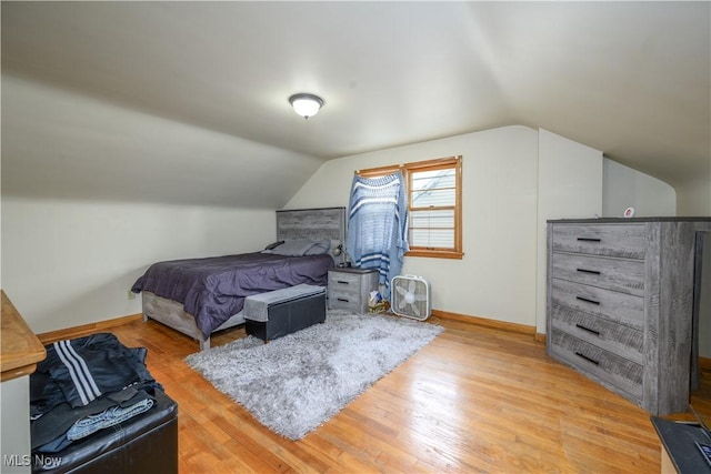 1923 15th St SW, Akron, OH 44314 - bedroom with vaulted ceiling, light wood-style floors, and baseboards