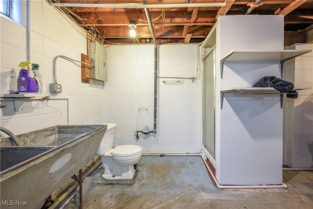 1923 15th St SW, Akron, OH 44314 - bathroom featuring toilet, electric panel, a shower stall, unfinished concrete floors, and concrete block wall