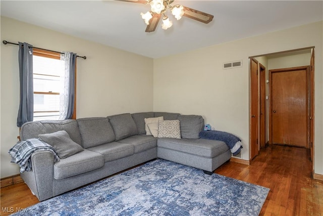 1923 15th St SW, Akron, OH 44314 - living room with a ceiling fan, wood finished floors, and baseboards