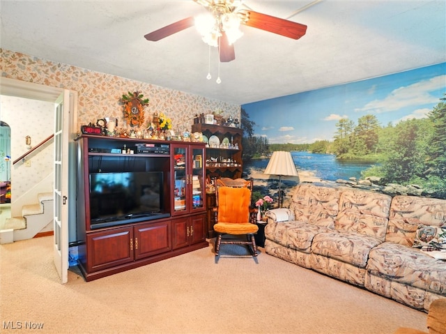3912 Austinburg Rd, Ashtabula, OH 44004 - carpeted living area with wallpapered walls, ceiling fan, and stairs