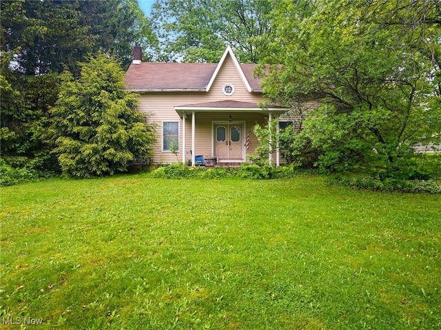 3912 Austinburg Rd, Ashtabula, OH 44004 - view of front of home with a front yard, covered porch, and a chimney
