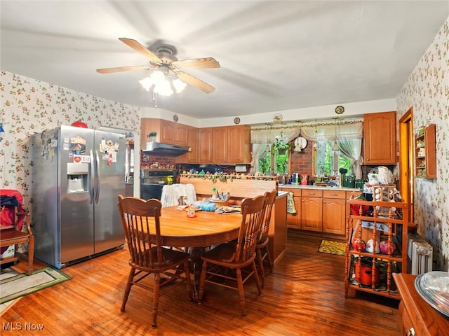 3912 Austinburg Rd, Ashtabula, OH 44004 - dining space with wallpapered walls, wood finished floors, ceiling fan, and radiator
