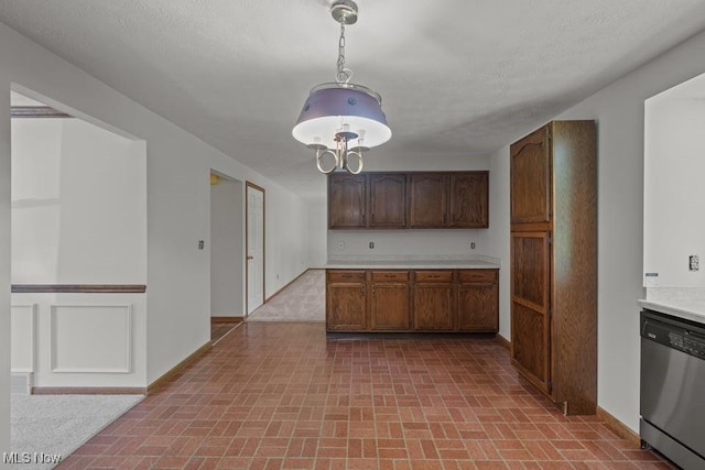 7124 Hollyhock Ln, Solon, OH 44139 - kitchen featuring stainless steel dishwasher, brick patterned floors, light countertops, and baseboards