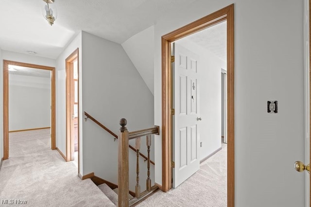 7124 Hollyhock Ln, Solon, OH 44139 - hallway featuring an upstairs landing, light colored carpet, baseboards, and lofted ceiling