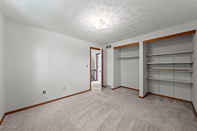 7124 Hollyhock Ln, Solon, OH 44139 - unfurnished bedroom with carpet floors, baseboards, two closets, and a textured ceiling