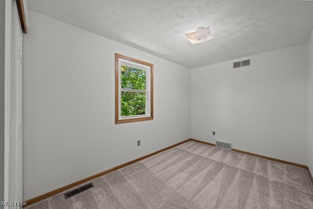 7124 Hollyhock Ln, Solon, OH 44139 - empty room featuring a textured ceiling, baseboards, and light carpet