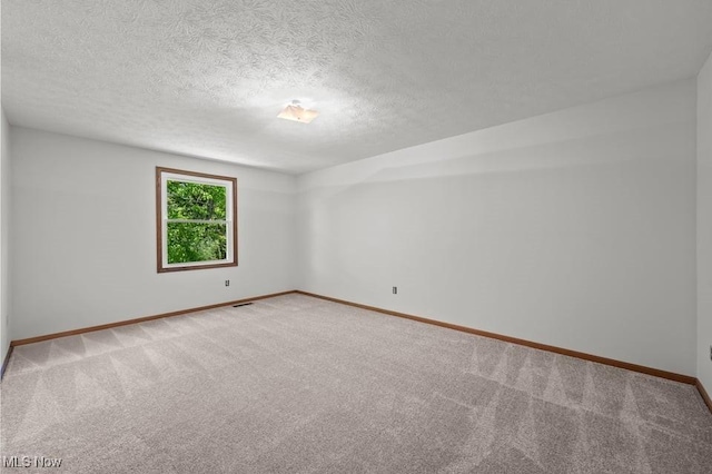 7124 Hollyhock Ln, Solon, OH 44139 - unfurnished room featuring light colored carpet, baseboards, and a textured ceiling