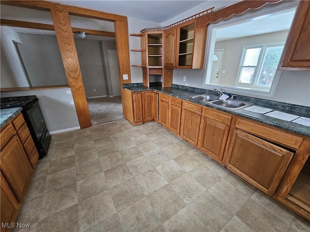2889 State Route 46 S, Jefferson, OH 44047 - kitchen with electric range, a sink, open shelves, dark countertops, and brown cabinetry