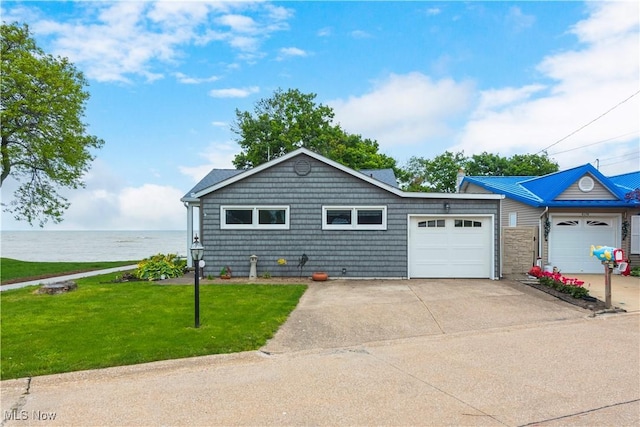 6178 Shadyside Dr, Vermilion, OH 44089 - ranch-style house with a garage, a front yard, concrete driveway, and a water view