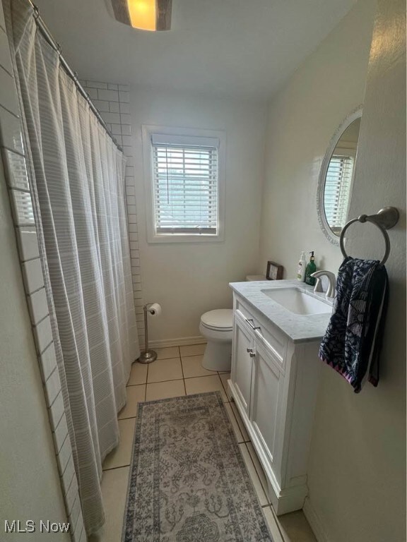 1505 N 14th St, Cambridge, OH 43725 - bathroom with vanity, toilet, tile patterned flooring, and a shower with curtain